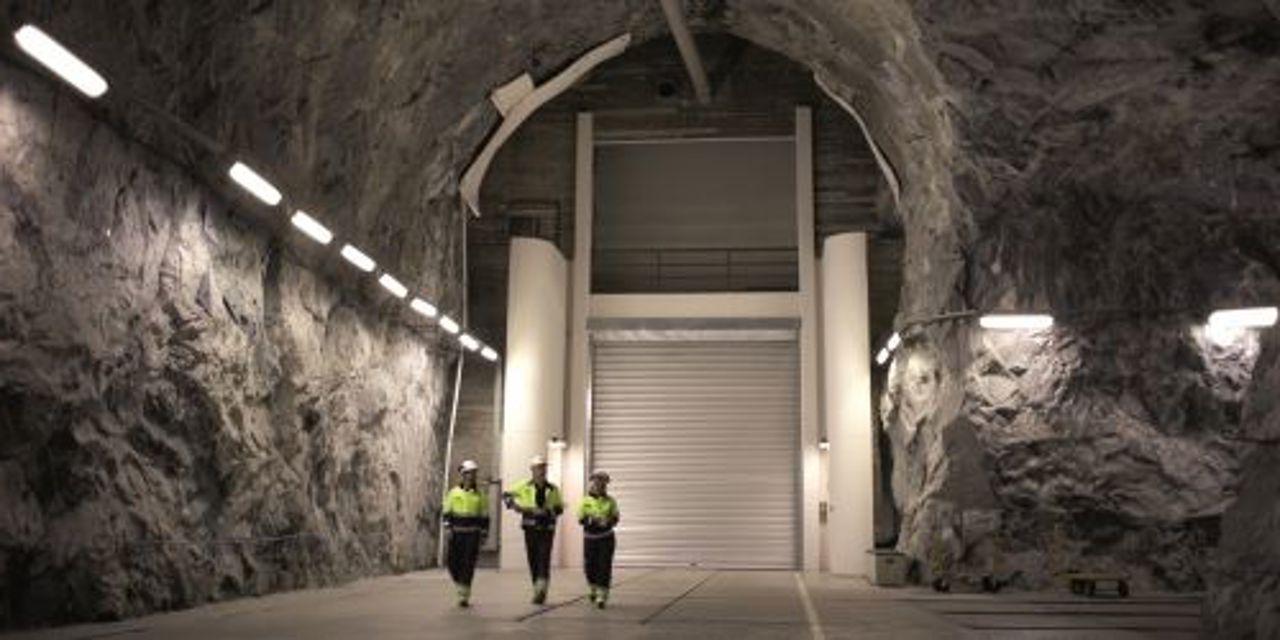 Three workers walking in tunnel